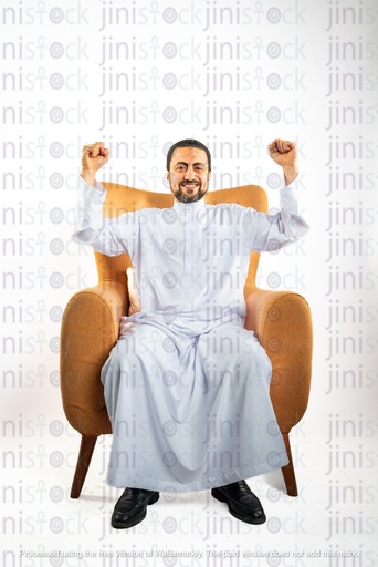 saudi khaliji man from gulf happy cheering while sitting on a chair