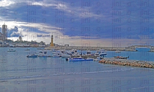 A beautiful beach in Alexandria and boats on it. while there were clouds in the sky. Alex Cournish