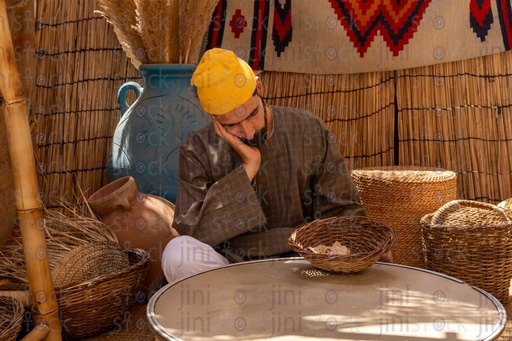 Egyptian farmer sleeping sitting in the hut 