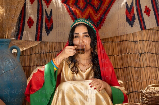 Egyptian peasant woman drinking a cup of tea