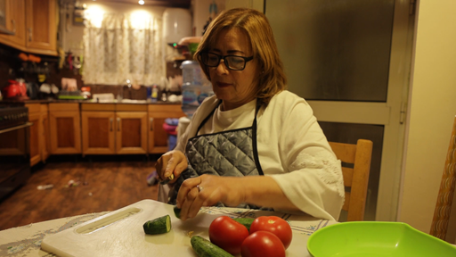 old woman cutting vegtables