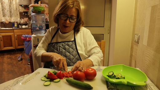 old woman making salad