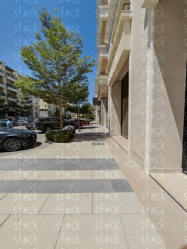 Sunlit walkway with patterned tiles