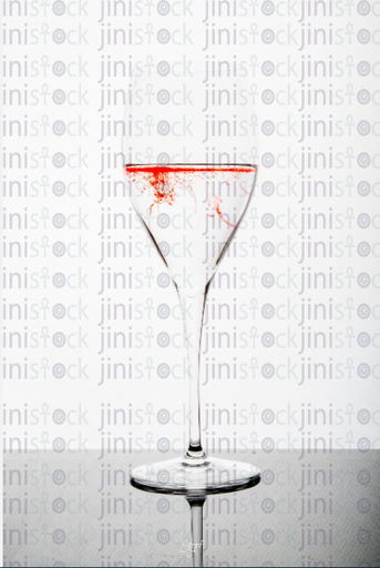 glass of water with red ink - stock image