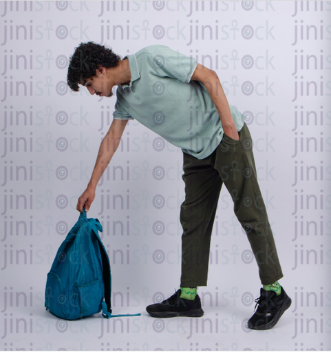 young man puting his back bag down - stock image