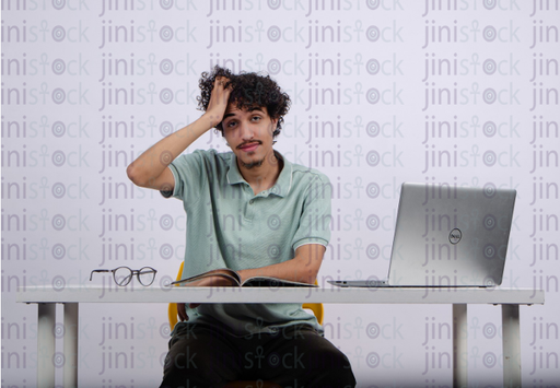 young man skratching his hair - stock image