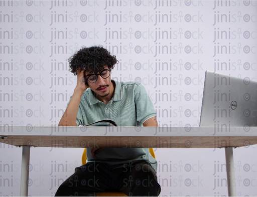 young man sleeping while reading a book - stock image